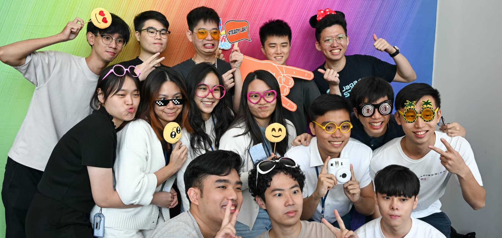 Batch of past GovTech interns having fun while posing for a photo at a photo booth