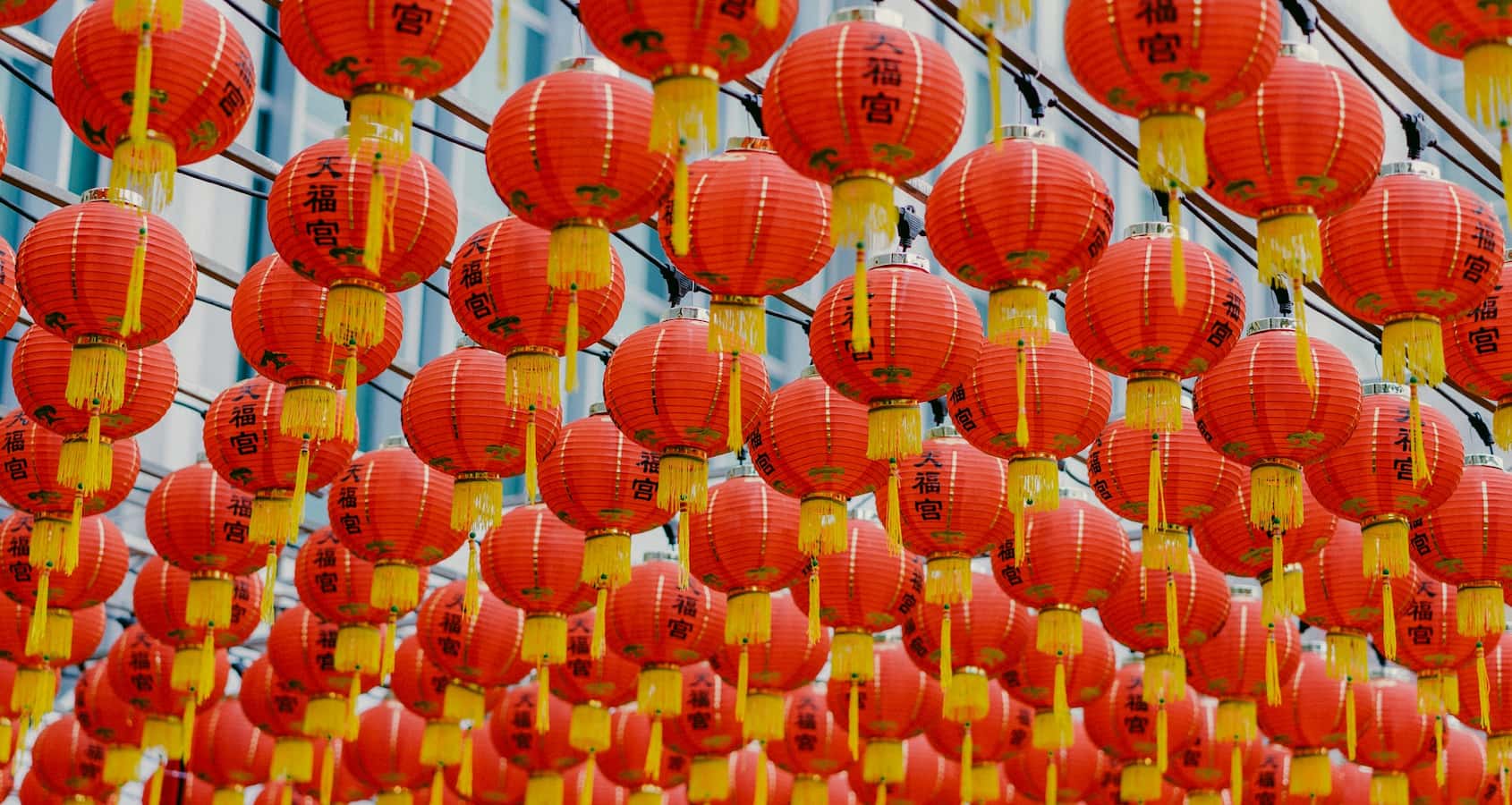 Red chinese laterns being hung up for CNY decorations.