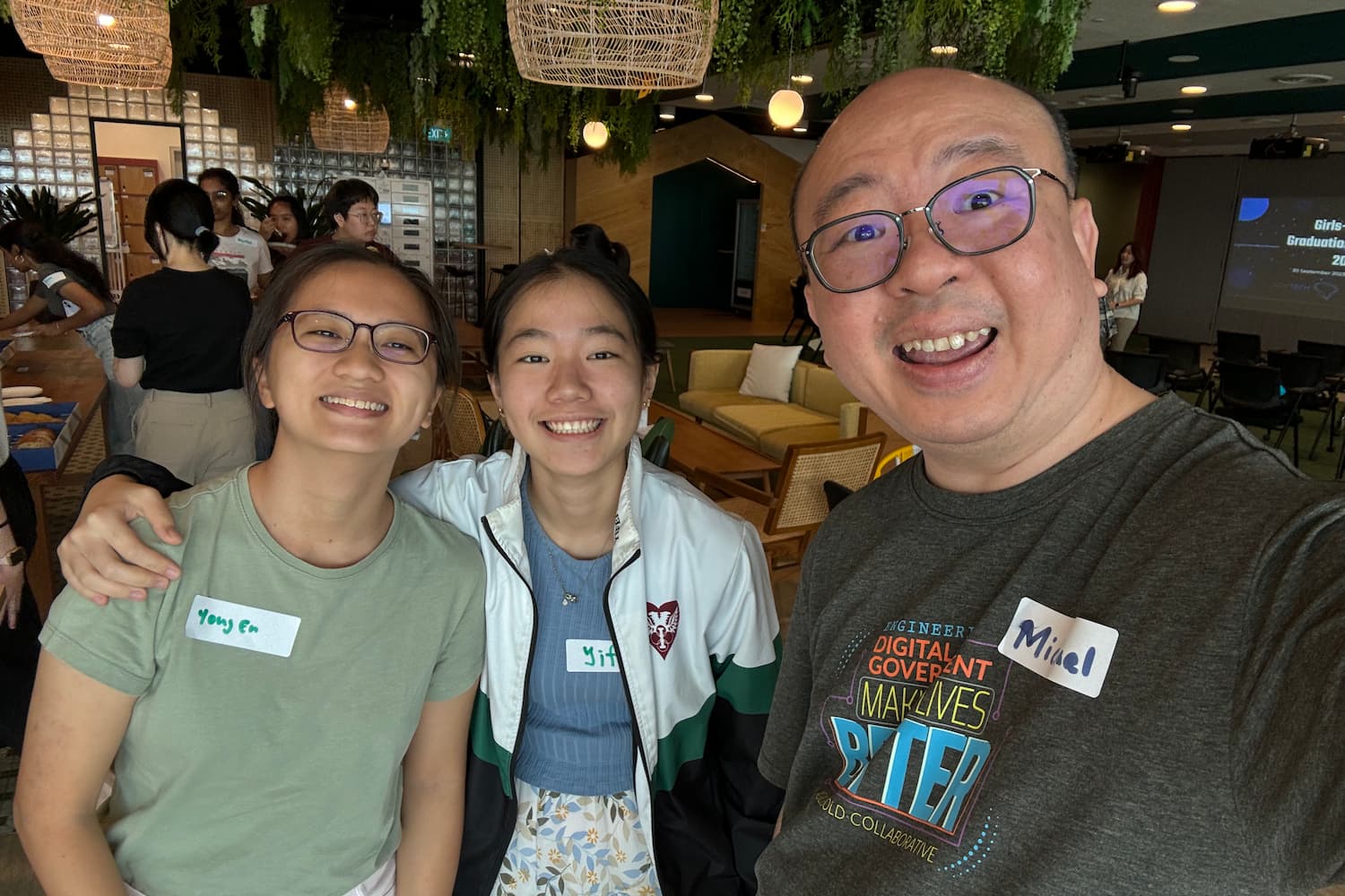 Yong En, her friend, and her mentor, Michael taking a picture together at a GovTech event