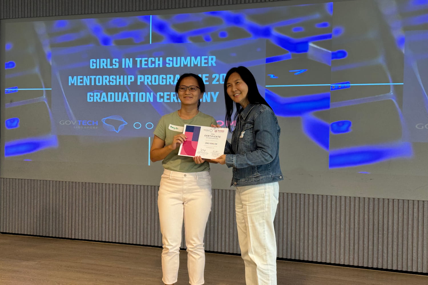 Yong En receiving a certificate of participation in the Girls in Tech Summer Mentorship Programme